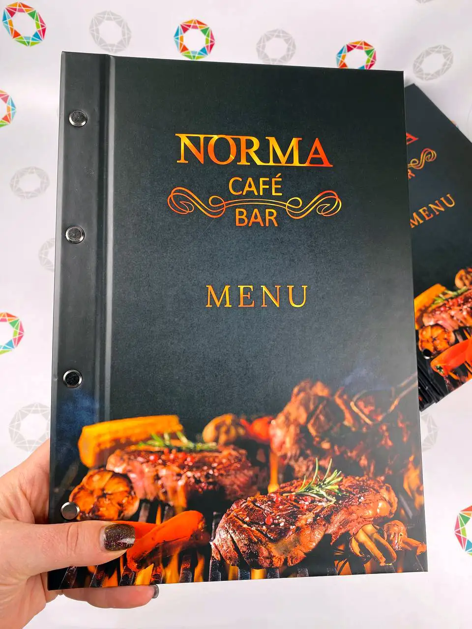 Norma menu in hand — hard cover with designer finish