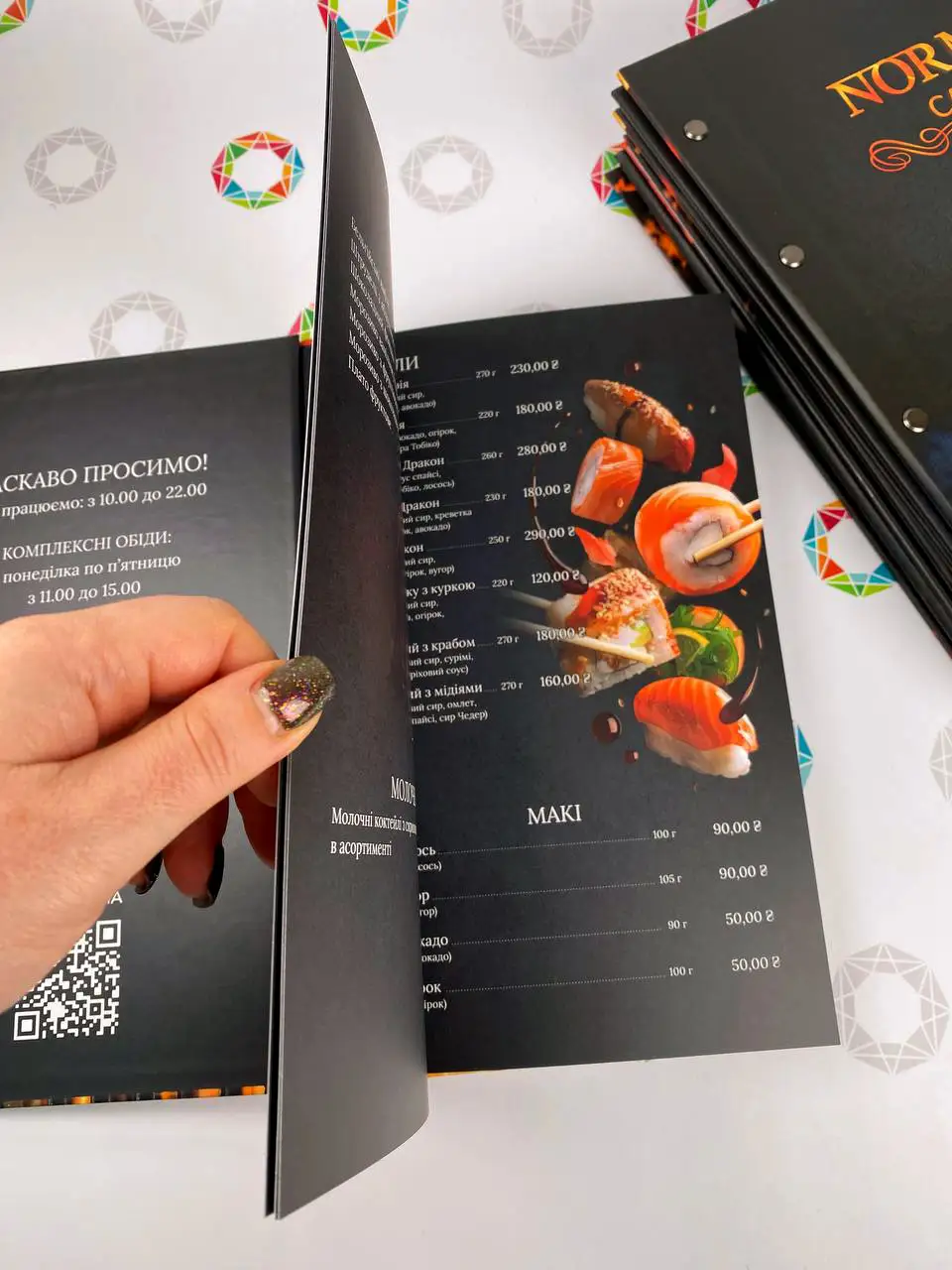 Spread of the Norma menu with inner pages under matte lamination