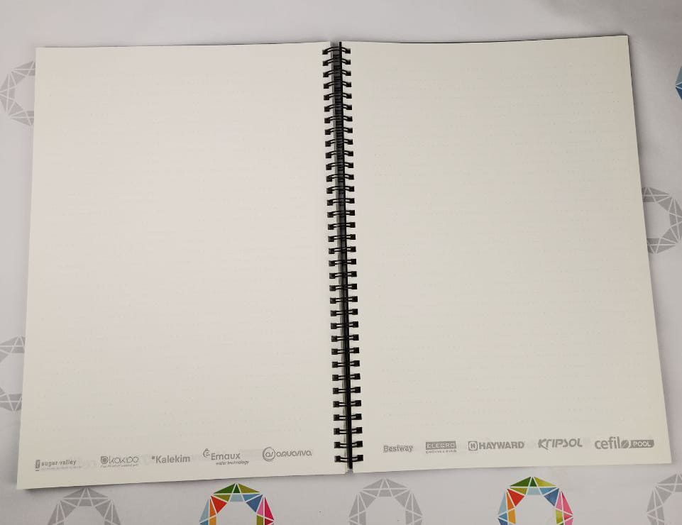 Black wire binding and an open spread of the inner block on cream Munken paper 90 gsm