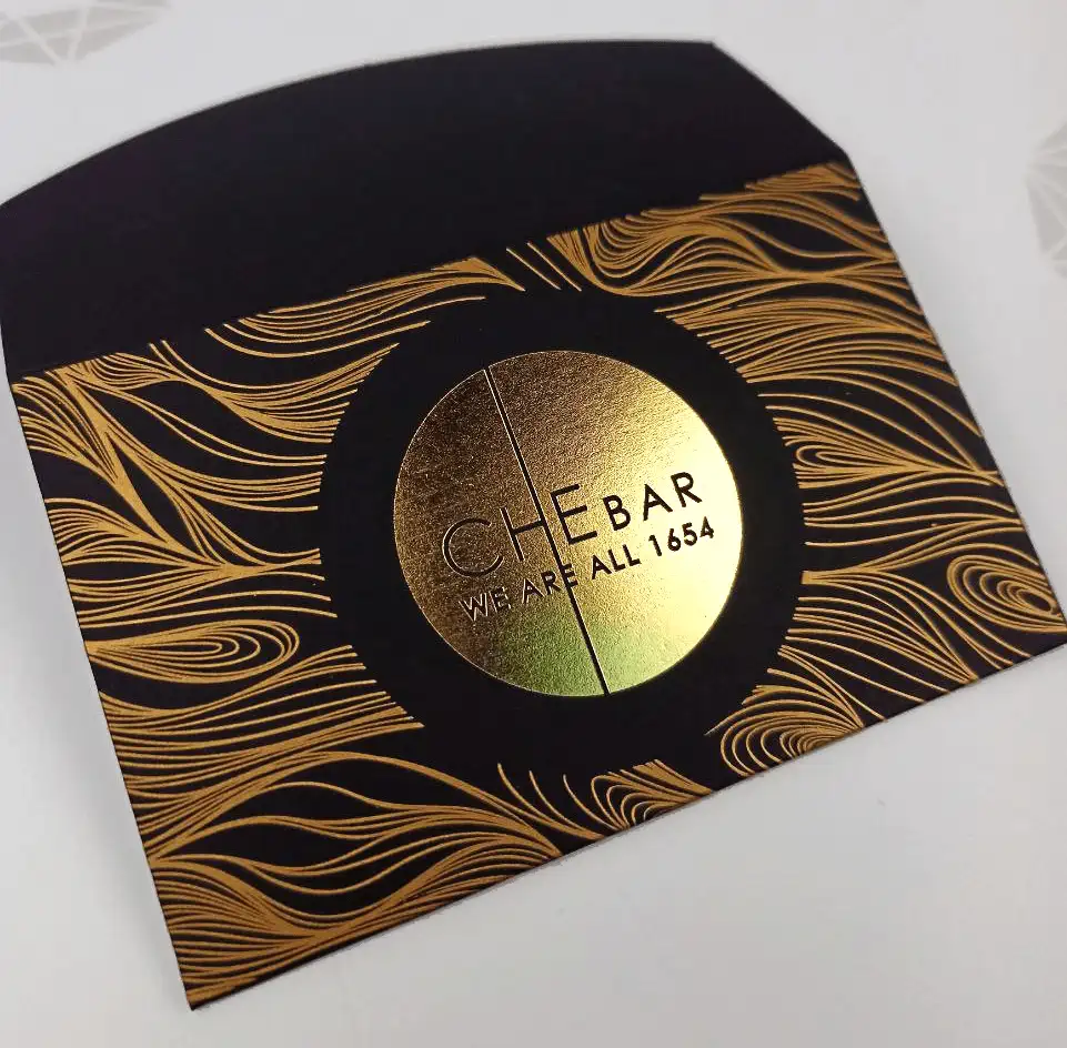 Black designer envelope with gold foil stamping and a bronze pattern, front
