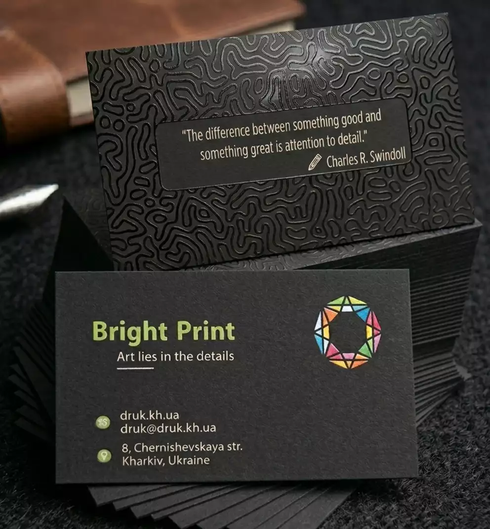 Example of business cards on Plike Black 330 gsm designer board. Gloss varnish, foil stamping, white + CMYK printing.